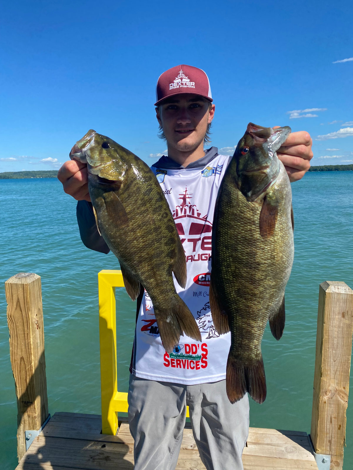 A pair of Lake St. Clair smallmouth bass held up on the dock